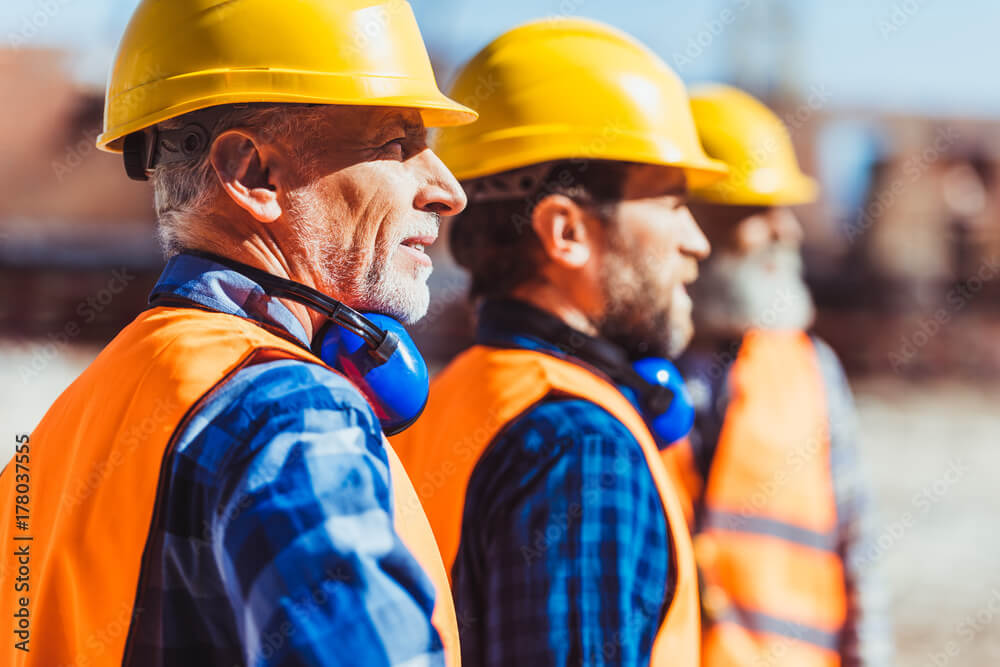 Construction Workers looking off in the distance