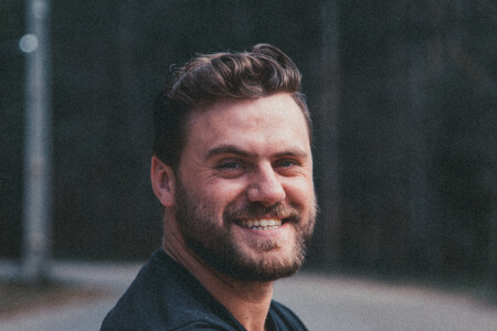 Older man with brown hair smiling