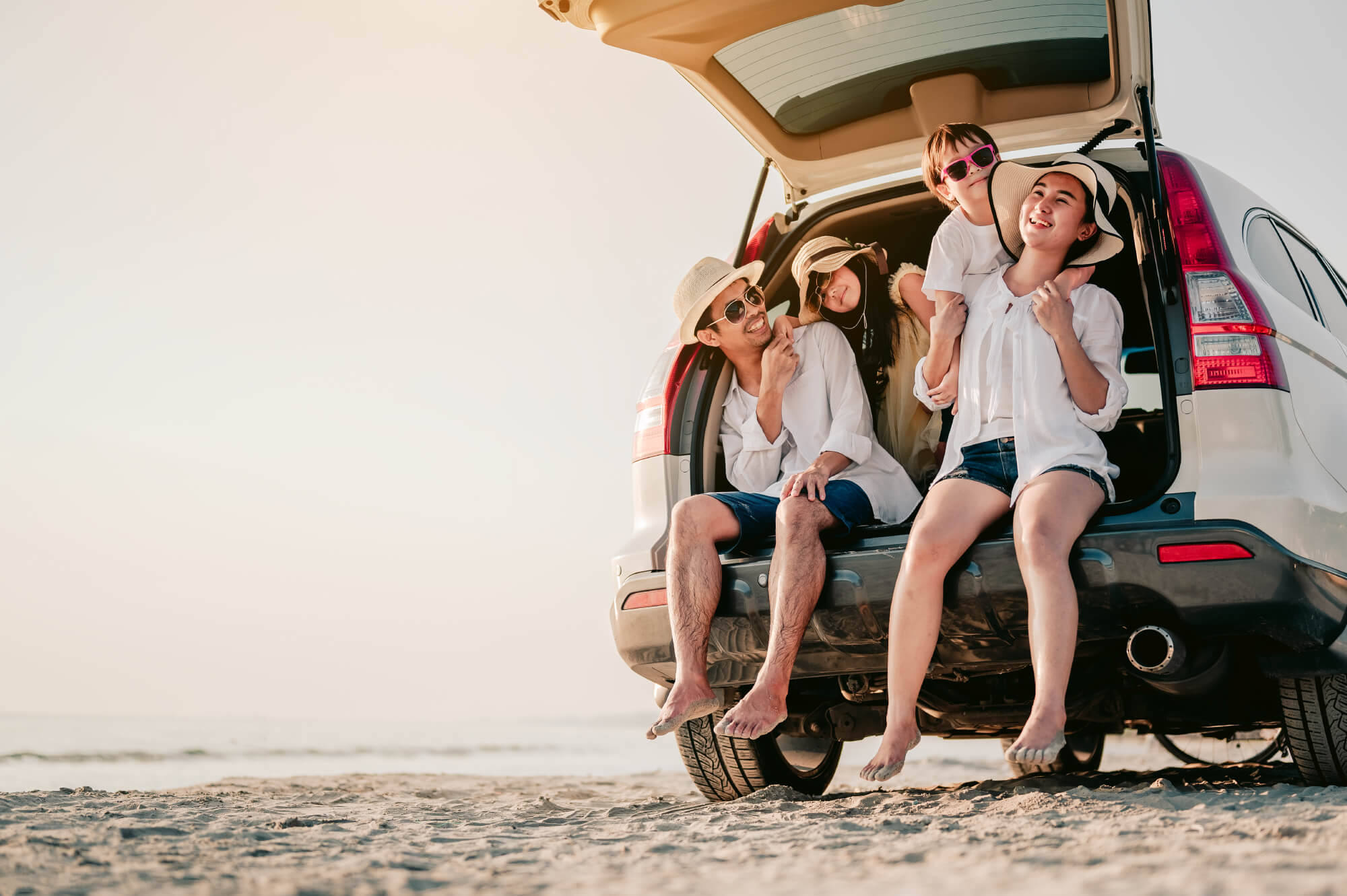 A family sitting in the back of an open van