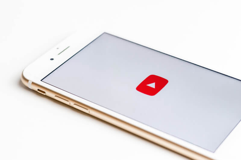 An image of the Youtube logo on a white phone